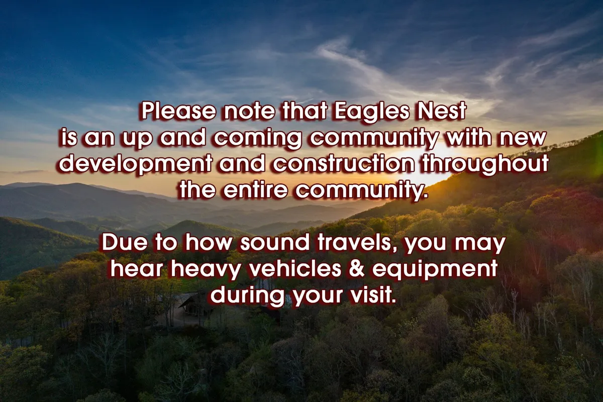 A sweeping mountain view at sunset stretches across the horizon, with greenery in the foreground. The image evokes the expansive natural beauty available to explore in the Eagles Nest area, inviting families to hike, bike, and enjoy the stunning scenery together.
